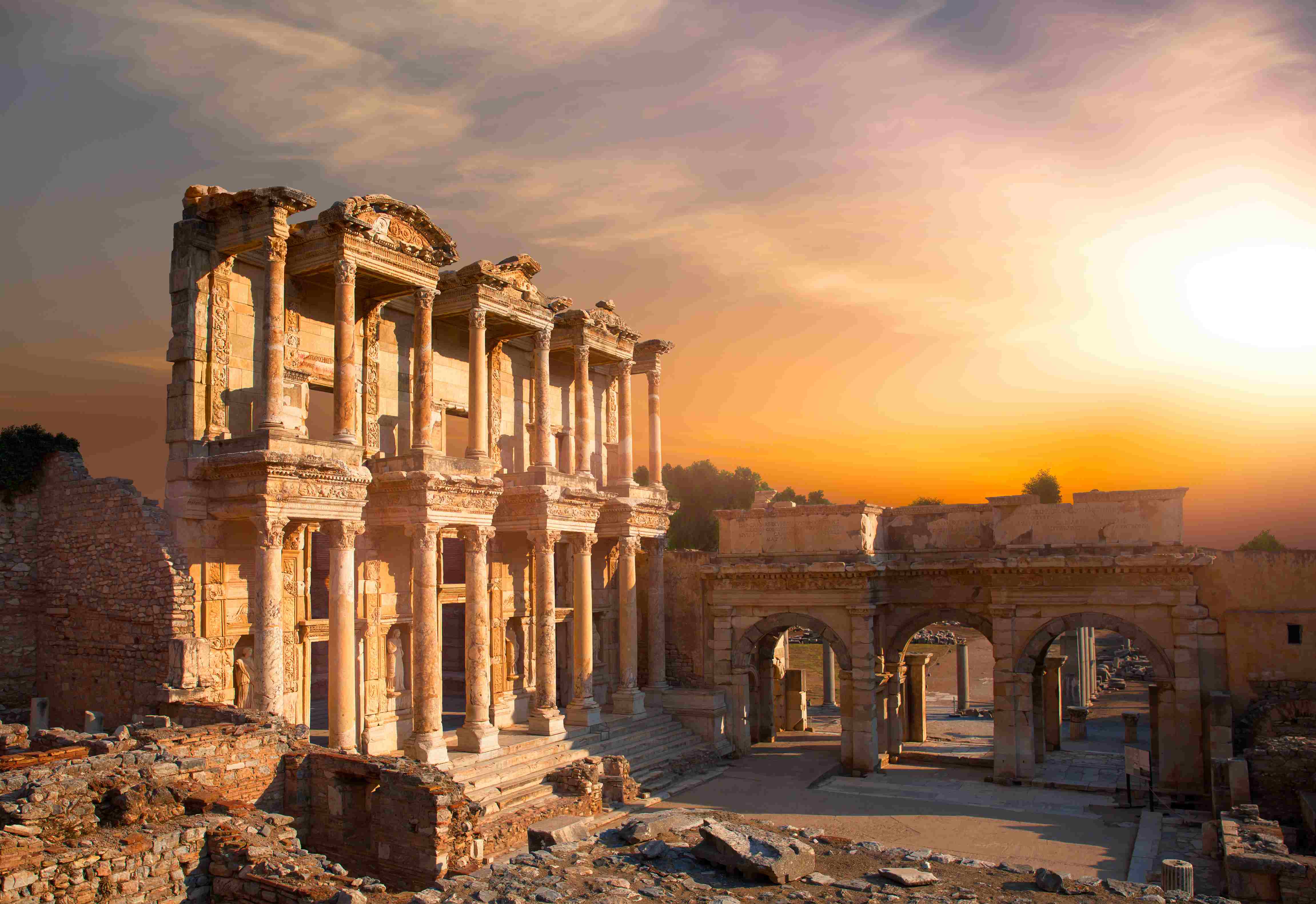 Ancient ruins of the Ephesus City in Turkey featuring the Celsus Library and Roman architecture at sunset